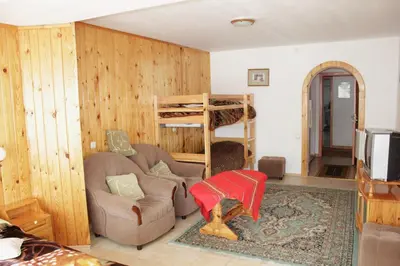a living room with a couch and a bunk bed at Hotel Elitza in Pamporovo