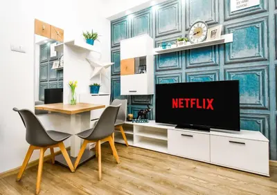 a living room with a tv and a table and chairs at 2BDR Heart of Sofia AC Fully Equipped in Sofia