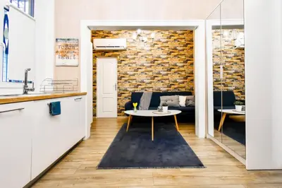 a living room with a table and a couch at 2BDR Heart of Sofia AC Fully Equipped in Sofia