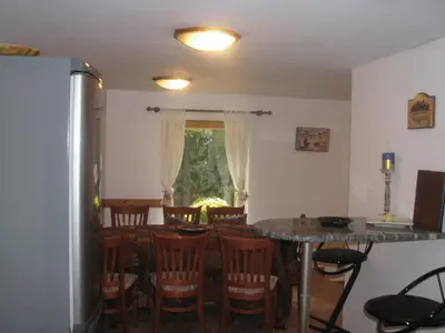 a kitchen and dining room with a table and chairs at Elitza Villa in Pamporovo