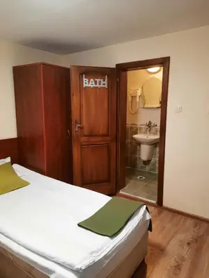 a bedroom with a bed and a bathroom with a sink at Villa Sveti Dimitar in Borovets