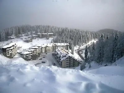 a resort in the snow with trees and buildings at Studio in Hotel Laplandia in Pamporovo