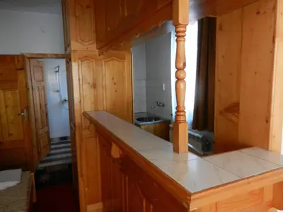 a kitchen with wooden cabinets and a counter top at Damianka Guest House in Bansko