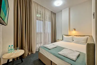a hotel room with a bed and a window at Augusta SPA Hotel in Hisarya