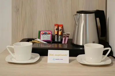 two cups on a table with a coffee maker at Augusta SPA Hotel in Hisarya