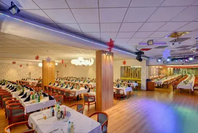 a dining room with white tables and chairs at Augusta SPA Hotel in Hisarya