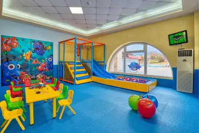 a classroom with a play room with a table and chairs at Augusta SPA Hotel in Hisarya