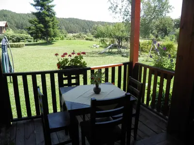 a table on a balcony with a view of a field at Pripetzite Hotel in Godlevo