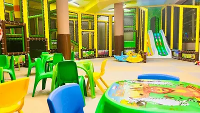 a childrens play room with a play table and chairs at Hotel Orpheus in Pamporovo