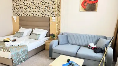 a small room with a bed and a couch at Hotel Orpheus in Pamporovo