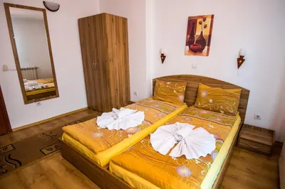 a bedroom with a bed with two pillows on it at Vien Guest House in Bansko