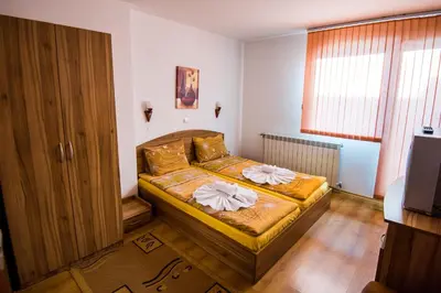 a bedroom with a bed with flowers on it at Vien Guest House in Bansko