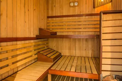 a small wooden sauna with two benches in it at Grami Hotel in Bansko