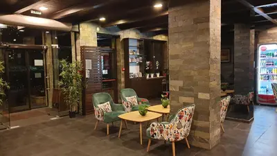 a restaurant with chairs and a table in a room at St George Ski & Holiday - Half Board & All Inclusive in Bansko