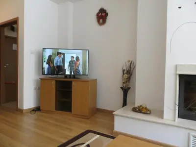 a living room with a flat screen tv on a stand at Apartment 