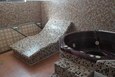 a bathroom with a bath tub in a tiled room at Apartment 