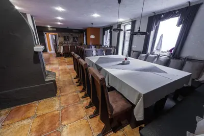 a dining room with a table and some chairs at Monastery 2 Aparthotel in Pamporovo
