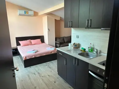 a small room with a bed and a sink at Guest House Dinevi in Sapareva Banya