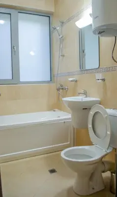 a bathroom with a white toilet and a sink at Guest House Dinevi in Sapareva Banya