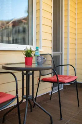 a table and two chairs on a porch at Luxor Apartment in Velingrad