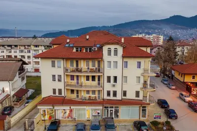 a group of buildings in a city with a street at Luxor Apartment in Velingrad
