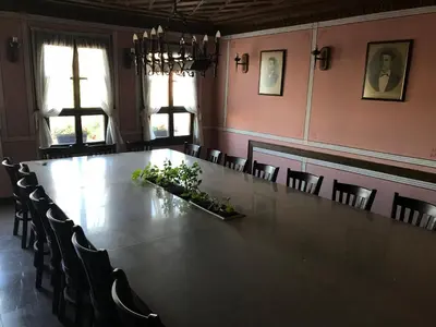 a large long table in a room with chairs at Къща Стария град in Plovdiv
