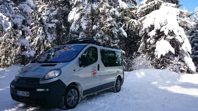 a small white van parked in the snow at TES Royal Plaza Apartments in Borovets