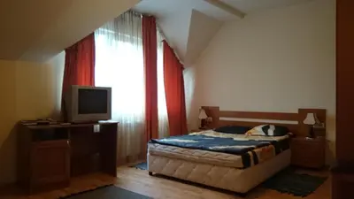 a bedroom with a bed and a tv and a window at TES Royal Plaza Apartments in Borovets