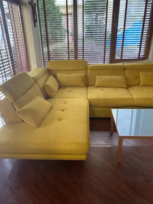 a large yellow couch in a room with windows at The Lake Villa in Smolyan