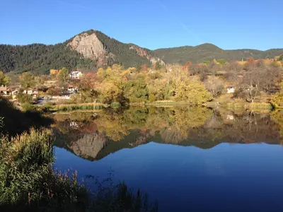 a view of a lake with mountains in the background at Семеен хотел Кристал in Smolyan