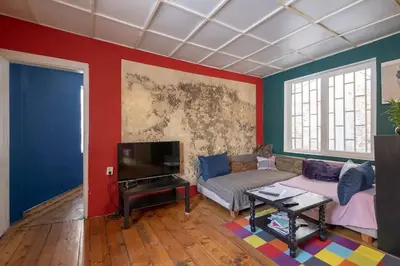 a living room with a couch and a tv at Cool Central Apartment in Sofia
