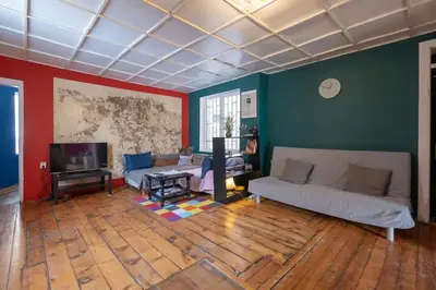 a living room with a couch and a tv at Cool Central Apartment in Sofia