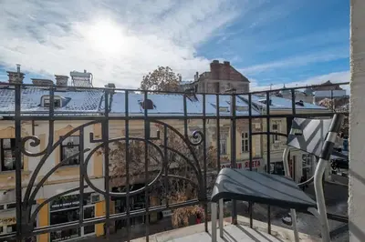 a balcony with a bench and a building at Cool Central Apartment in Sofia