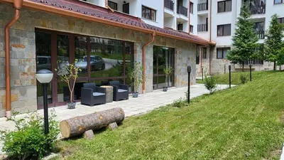 a building with a large window with a car in it at Borovets Gardens Apartments in Borovets