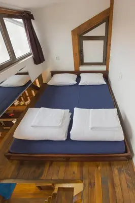 two bunk beds in a room with two windows at Mini Apartment Best Rest in Plovdiv