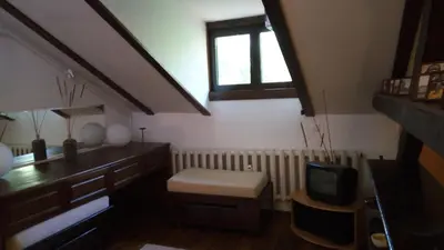 a room with an attic with a table and a tv at Mini Apartment Best Rest in Plovdiv