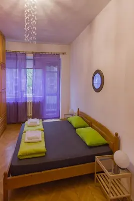 a bedroom with a large bed with green pillows at Maritza Apartment in Plovdiv
