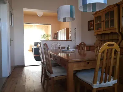a dining room with a wooden table and chairs at Maritza Apartment in Plovdiv