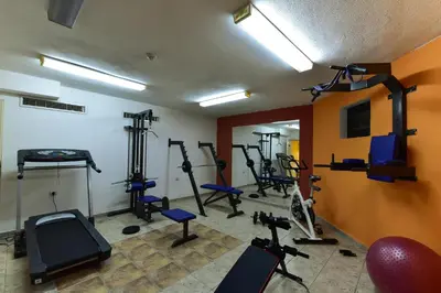 a gym with several tread machines in a room at Hotel Ida in Bansko