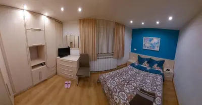 a bedroom with a bed and a desk and a computer at Libera in Sofia