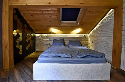 a bed in a room with a brick wall at Art Spa Villa Gal in Velingrad