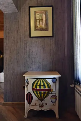 a small table with a painting on a wall at Art Spa Villa Gal in Velingrad