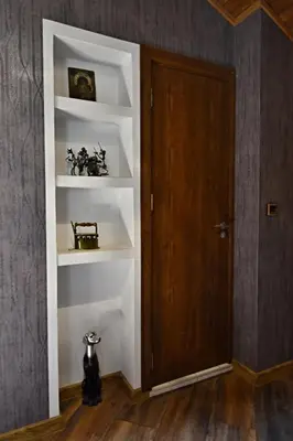 a cat sitting on a shelf next to a door at Art Spa Villa Gal in Velingrad