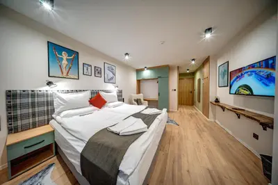 a bedroom with a large bed in a room at Mountain Lake Hotel in Smolyan