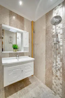 a bathroom with a white sink and a shower at Unique atmosphere with golden standard design in Sofia