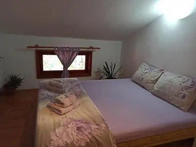 a bedroom with a bed with towels on it at Guest House Ganovi in Kalofer