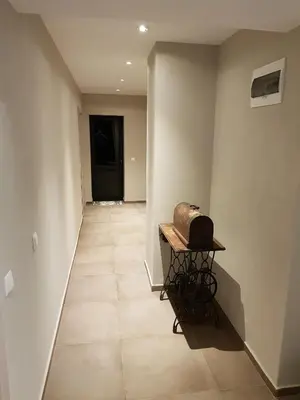 a hallway with a table with a hat on it at Mihaylova kushta in Lyubosh