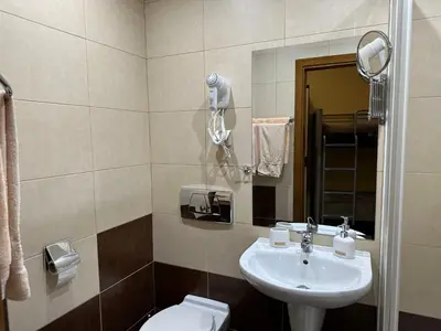 a bathroom with a sink and a toilet at Apartments & Rooms Royal Plaza in Borovets