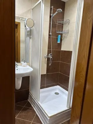 a bathroom with a shower and a sink at Apartments & Rooms Royal Plaza in Borovets