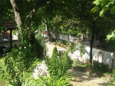 a garden with a fence and some plants at Balkanski chanove in Botevgrad